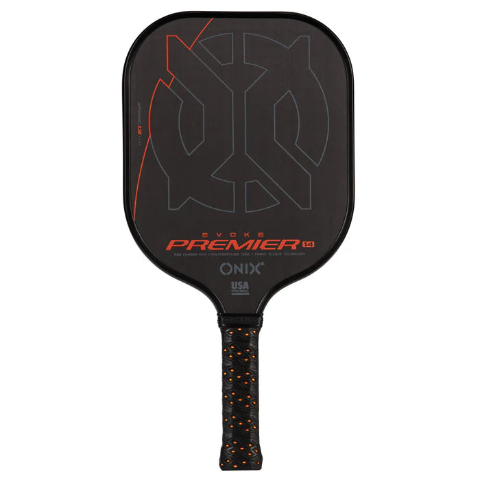 Introducing the Evoke Premier Pro Raw Carbon Pickleball Paddle by Onix: This lightweight paddle features a carbon fiber surface with Evoke Premier and Onix branding on the face. It boasts a striking orange and gray geometric design, complemented by a textured black grip with orange accents.