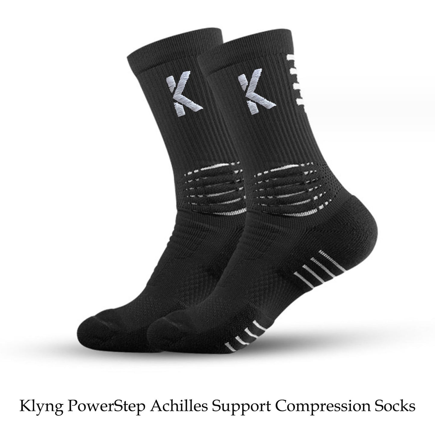 These PowerStep Achilles Support Compression Socks by Klyng, perfect for pickleball enthusiasts, are designed in black with silver stripe patterns and the letter K on the cuffs. They offer outstanding Achilles support to enhance your performance during intense matches.