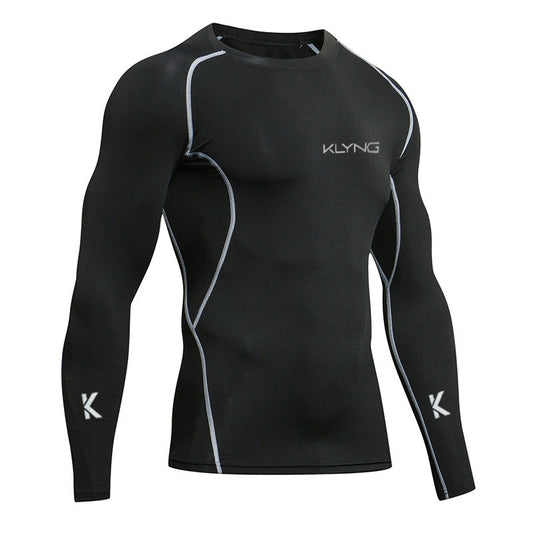 The Men’s Pro Pickleball Muscle Up Compression Long Sleeve Shirt in black by Klyng features stylish white seam accents and a subtle logo on the chest and sleeves. Made with breathable fabric, it incorporates advanced compression technology to deliver superior performance and comfort on the court.