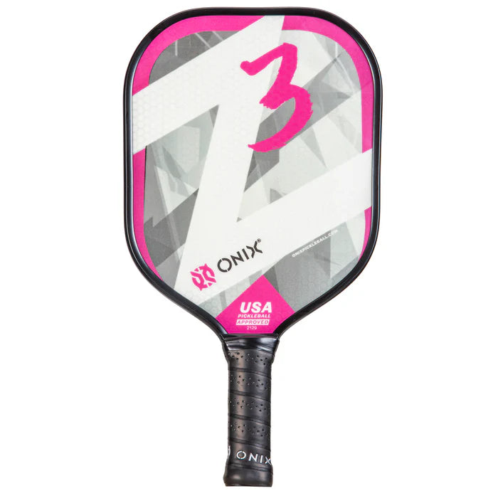 Close-up of the Z3 Pickleball Paddle by Onix, showcasing its wide body design, black handle, and a striking composite face in pink, gray, and white with a bold pink number 3. The brand name "Onix" is prominently displayed along with the indication that it is USA Pickleball Approved.