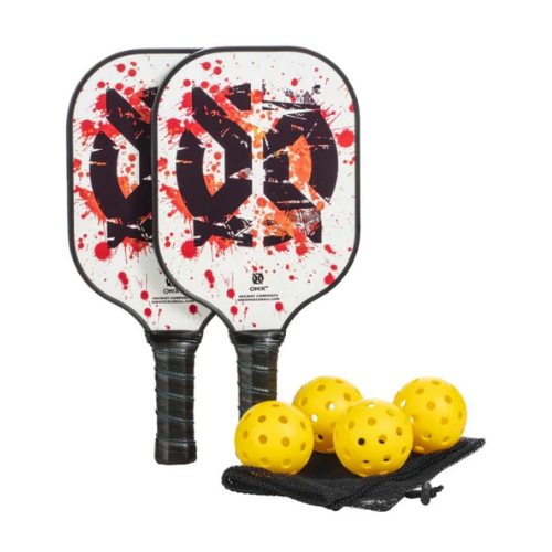 Two chic Recruit Composite Pickleball Paddles by Onix, featuring abstract red and black splatter designs, stand upright. Accompanying them are four yellow perforated balls tucked neatly into a black mesh bag, completing the set.