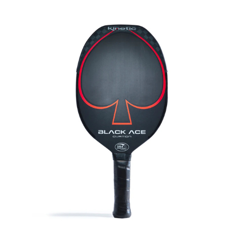 The Prokennex Black Ace Ovation Pickleball Paddle, crafted in black carbon, showcases a bold red spade on its surface. The paddle is adorned with the names "Kinetic" and "Black Ace Ovation" as well as various certification logos. Enhanced by kinetic technology, it features a handle wrapped in sleek black grip tape to ensure optimal control.