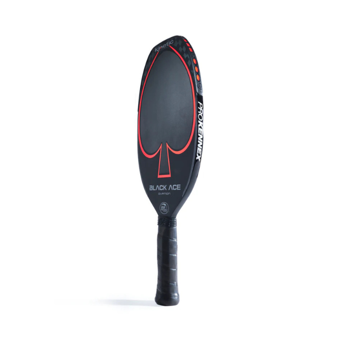 The Black Ace Ovation Pickleball Paddle by Prokennex features innovative kinetic technology and a stylish black design highlighted with red accents. A central spade artwork enhances its look, accompanied by the 'Black Ace' and 'Prokennex' text. This carbon paddle includes a branded grip handle, all beautifully displayed against a pristine white background.