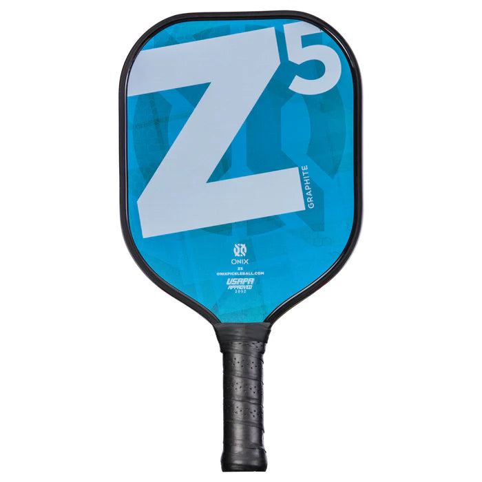 The Graphite Z5 v2 Pickleball Paddle by Onix, ideal for intermediate players, boasts a blue face adorned with an eye-catching white Z5 design. Its Nomex honeycomb core delivers impressive control and power, paired with a black handle prominently featuring the Onix brand and Graphite label at the center.