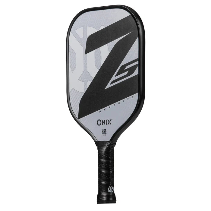 The Onix Graphite Z5 v3 Pickleball Paddle showcases a stylish black and grey design with its name boldly featured on the surface. Its handle is wrapped in black grip tape, offering a tennis-style shape for enhanced control.