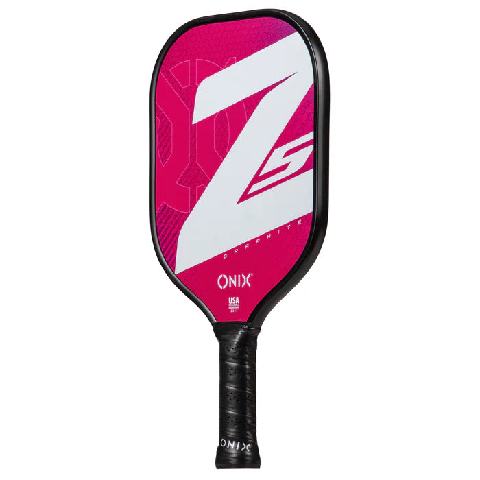 The Graphite Z5 v3 Pickleball Paddle, from the Onix brand, is available in pink and white with a striking Z5 design on its face. It includes a tennis handle shape wrapped in black grip tape for superior comfort and control.