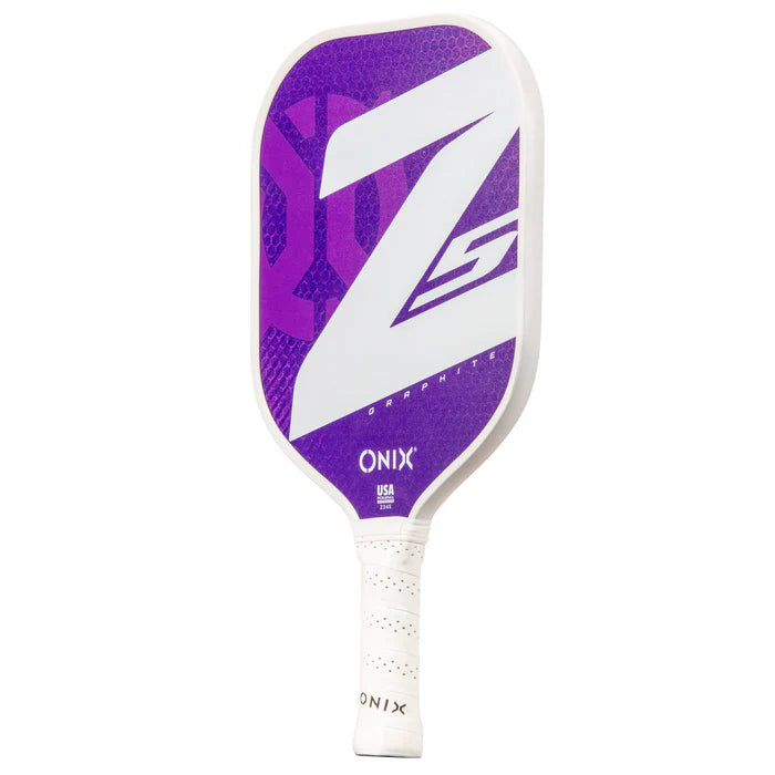 The Graphite Z5 v3 Pickleball Paddle by Onix features a sophisticated design with a white handle and a dynamic purple face, highlighted by a striking Z5 motif.