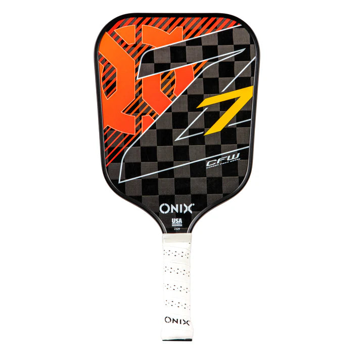 The Onix Graphite Z7 v2 Pickleball Paddle, approved by USA Pickleball, boasts a checkered design in black and gray with orange and red abstract shapes and a yellow accent. Crafted from lightweight carbon fiber, this performance paddle features a white grip with "ONIX" printed on it and is labeled C.F.W.