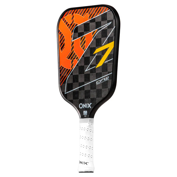 The Graphite Z7 v2 Pickleball Paddle by Onix features a checkered black and orange face with an orange "Z" and a yellow number 7. It has a lightweight carbon fiber handle wrapped in white, proudly displaying the Onix brand at the base, and is USA Pickleball Approved.