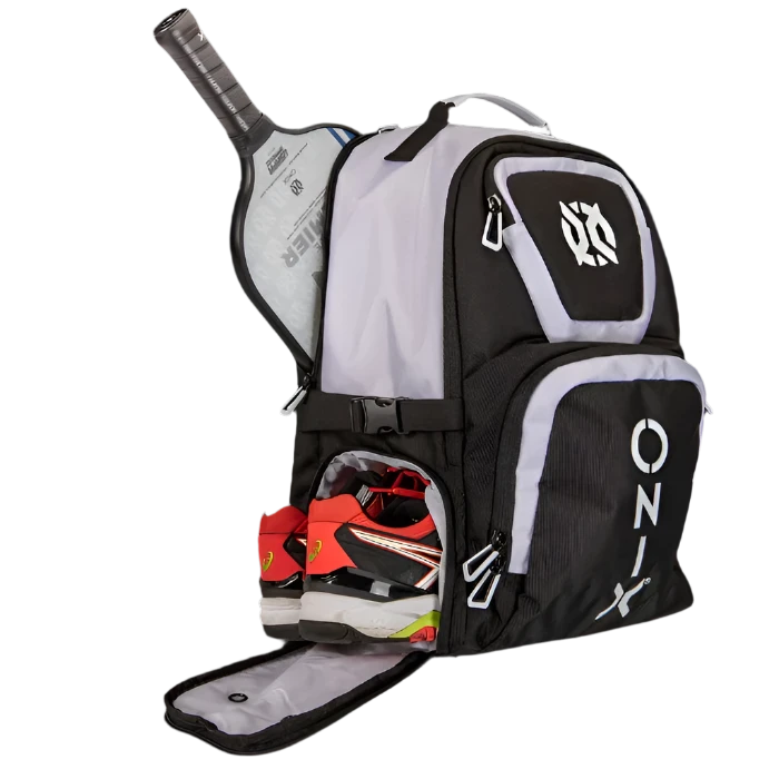 The Pro Team Pickleball Backpack by Onix, available in black and white, is made from durable polyester and includes several compartments such as a side pocket for your paddle and a bottom compartment for red and white sports shoes. Ideal for athletes needing plenty of storage while on the move.